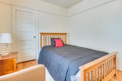 a bedroom with a bed with a red pillow on it at 2 Mi to USC Central Home in Los Angeles! in Los Angeles