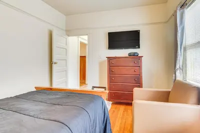 a bedroom with a bed and a dresser with a tv at 2 Mi to USC Central Home in Los Angeles! in Los Angeles