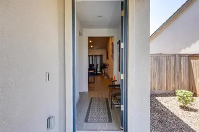 an open door of a house with a hallway at 9 Mi to Dtwn Bakersfield Pet-Friendly Home in Bakersfield