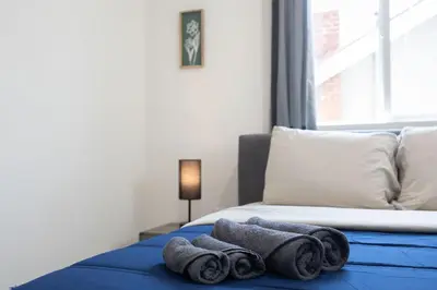 a bedroom with a bed with towels on it at Sophisticated Getaway Hollywood & Dtla in Los Angeles