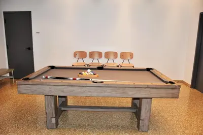 a ping pong table with three ping pong chairs at Stylist Downtown LA Gateway- Studio Apt in Los Angeles