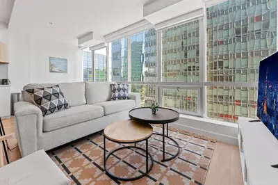 a living room with a couch and a table at Stylist Downtown LA Gateway- Studio Apt in Los Angeles