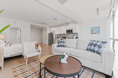 a living room with a couch and a table at Stylist Downtown LA Gateway- Studio Apt in Los Angeles