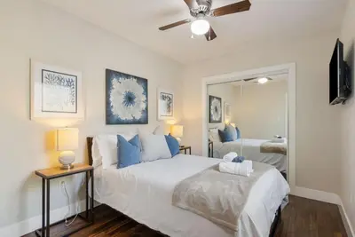 a bedroom with a large bed and a mirror at Travel Haven - Great Location - Quiet Area in Long Beach