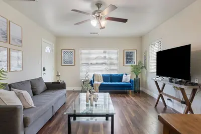 a living room with a couch and a flat screen tv at Travel Haven - Great Location - Quiet Area in Long Beach