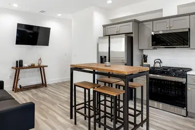 a kitchen with a table and a stove top oven at Contemporary Retreat Hollywood & DTLA in Los Angeles