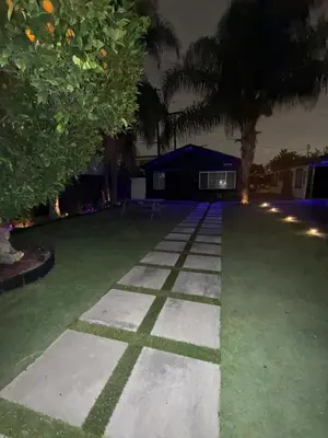 a garden at night with trees and a building at LUXURY VILLA Estate Oasis in Downey