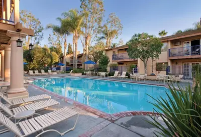 a swimming pool with lounge chairs in a resort at Wyndham Dolphin's Cove 1BR Suite with Resort Access in Anaheim