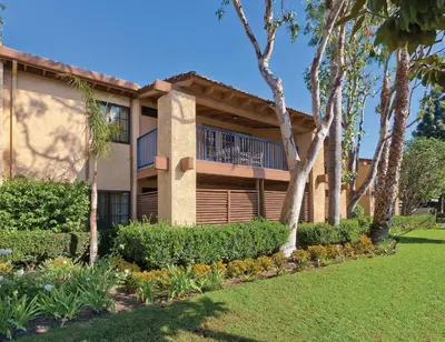 a building with a balcony and some trees at Wyndham Dolphin's Cove 1BR Suite with Resort Access in Anaheim