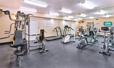 a gym with several tread machines in a room at Wyndham Dolphin's Cove 1BR Suite with Resort Access in Anaheim