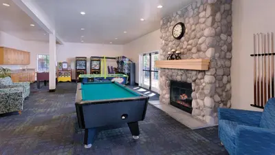 a living room with a pool table and a fireplace at Wyndham Dolphin's Cove 1BR Suite with Resort Access in Anaheim