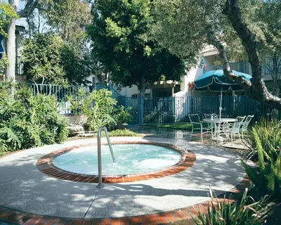 a small pool with a table and chairs in a yard at Wyndham Dolphin's Cove 2BR Suite with Resort Access in Anaheim