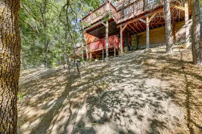 a house in the woods with trees in front of it at Between Big Bear and Lake Arrowhead - Cabin with View! in Running Springs