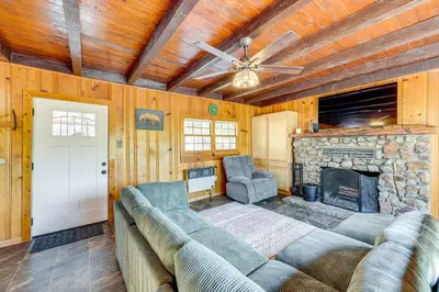 a living room with a couch and a fireplace at Between Big Bear and Lake Arrowhead - Cabin with View! in Running Springs