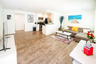 a living room with a couch and a table at Cozy Stylish 1-Bedroom In Hollywood With Free Gated Parking in Los Angeles