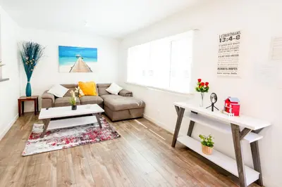 a living room with a couch and a table at Cozy Stylish 1-Bedroom In Hollywood With Free Gated Parking in Los Angeles