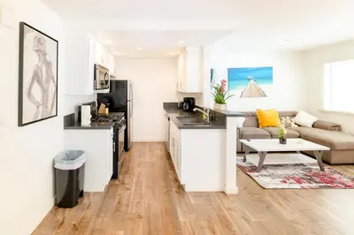 a kitchen and living room with a couch and a table at Cozy Stylish 1-Bedroom In Hollywood With Free Gated Parking in Los Angeles