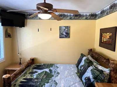 a bedroom with a bed and a ceiling fan at Best View of the Lake! Huge Deck! in Crestline