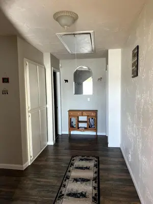 an empty room with a hallway with a door and a rug at Best View of the Lake! Huge Deck! in Crestline
