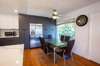 a dining room with a glass table and chairs at Renovated Culver City Escape Walkable WFH in Los Angeles