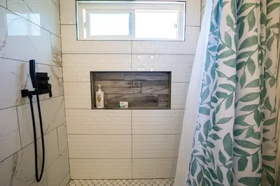 a bathroom with a fireplace in the shower at Renovated Culver City Escape Walkable WFH in Los Angeles