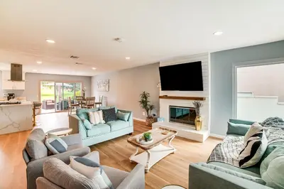 a living room with two couches and a tv at Golf, Swim, Relax Family Retreat in Corona! in Corona