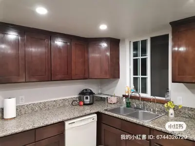 a kitchen with wooden cabinets and a sink at 1 bedroom in a quiet neighborhood near the main street - Room B in Rowland Heights