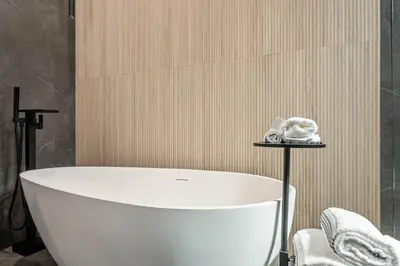 a bathroom with a white bath tub in a room at The Valley Nest Backyard Gameroom in Los Angeles