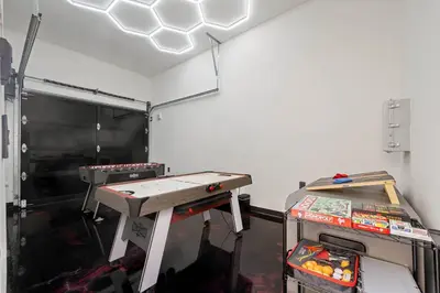 a room with a ping pong table in a garage at The Valley Nest Backyard Gameroom in Los Angeles