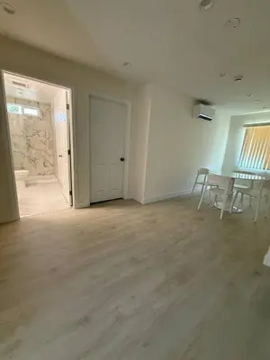 an empty living room with a table and chairs at San Marino guest house in Los Angeles