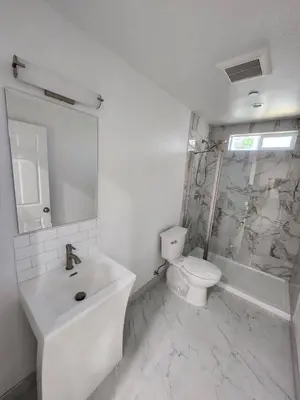 a white bathroom with a sink and a toilet at San Marino guest house in Los Angeles