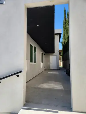 a hallway leading into a building with a black ceiling at San Marino guest house in Los Angeles