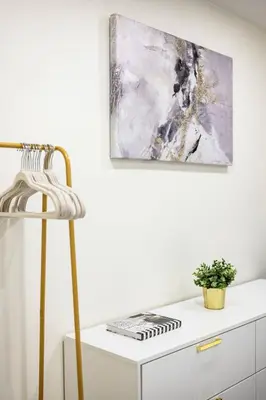 a white cabinet with a painting on the wall at 1 Block to Beach Heaven Chic 2BD in Manhattan Beach