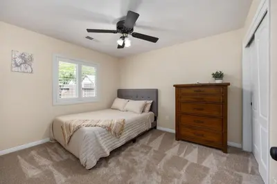 a bedroom with a bed and a ceiling fan at Relaxing 4BR 2BA Sleeps 8 Family Friendly in Bakersfield