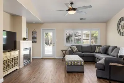 a living room with a couch and a tv at Relaxing 4BR 2BA Sleeps 8 Family Friendly in Bakersfield