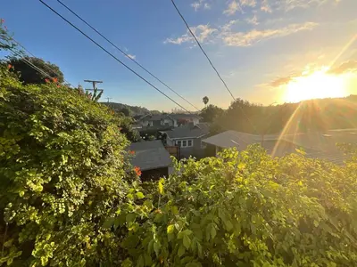 a view of a house with the sun in the sky at Montecito Heights Hideaway in Los Angeles
