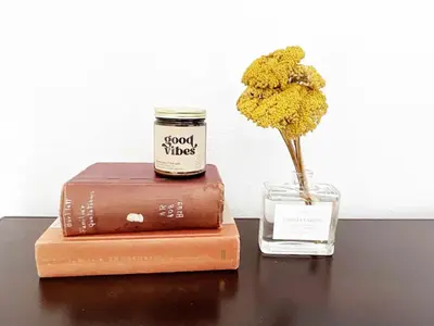 a book and a jar with a flower in a vase at Montecito Heights Hideaway in Los Angeles