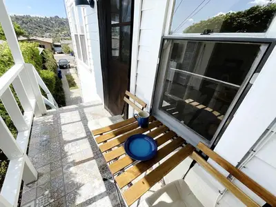 a wooden bench on the porch of a house at Montecito Heights Hideaway in Los Angeles