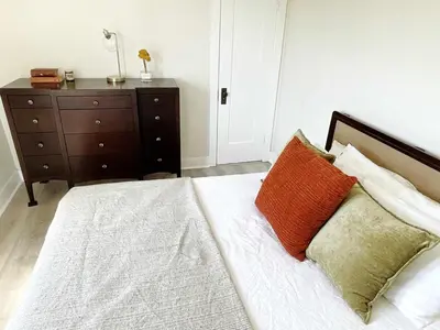 a bedroom with a bed with two pillows and a dresser at Montecito Heights Hideaway in Los Angeles