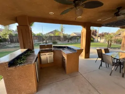 an outdoor kitchen with a ceiling fan and a patio at Cadbury 4BR Outdoor Kitchen Sleeps 8 Peaceful in Bakersfield