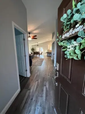 a hallway with a door and a living room at Cadbury 4BR Outdoor Kitchen Sleeps 8 Peaceful in Bakersfield
