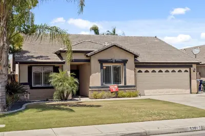 a house with a for sale sign in front of it at 4bdrm 2bath Modern Getaway KING Bed Sleeps 8 in Bakersfield