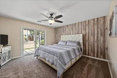 a bedroom with a bed and a ceiling fan at 4bdrm 2bath Modern Getaway KING Bed Sleeps 8 in Bakersfield