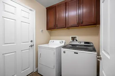 a small kitchen with a washer and dryer at 4bdrm 2bath Modern Getaway KING Bed Sleeps 8 in Bakersfield