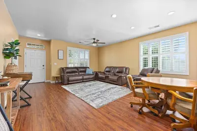 a living room with leather furniture and a table at Luxury Gated Retreat Golf Course Views Sleeps 8 in Bakersfield