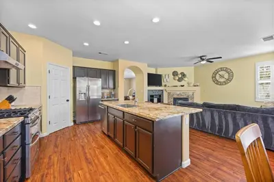 a large kitchen and living room with a couch at Luxury Gated Retreat Golf Course Views Sleeps 8 in Bakersfield