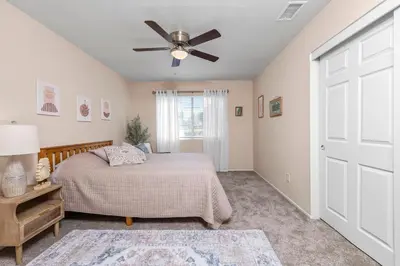 a bedroom with a bed and a ceiling fan at Modern Southwest Escape 2 Master Bedrooms in Bakersfield