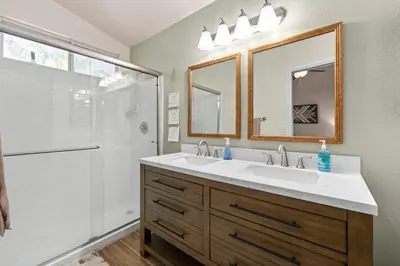 a bathroom with a double sink and a shower at Modern Southwest Escape 2 Master Bedrooms in Bakersfield