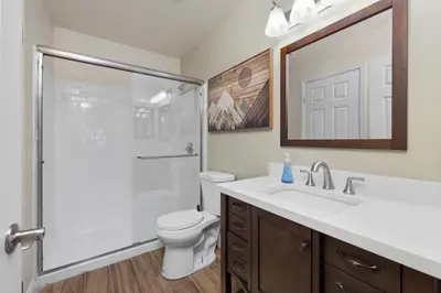 a bathroom with a shower and a toilet and a sink at Modern Southwest Escape 2 Master Bedrooms in Bakersfield