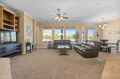 a living room with leather furniture and a flat screen tv at Spacious 4BR 3BA Home KING Suite Pool Sleeps 8 in Bakersfield